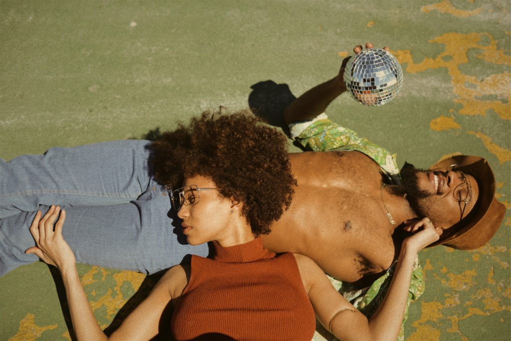 Image of a woman laying her head on a man's stomach. Showing the type of marriage you can start with premarital counseling for black couples in Atlanta. Through prepare enrich premarital counseling you can find the strengths of your relationship.
