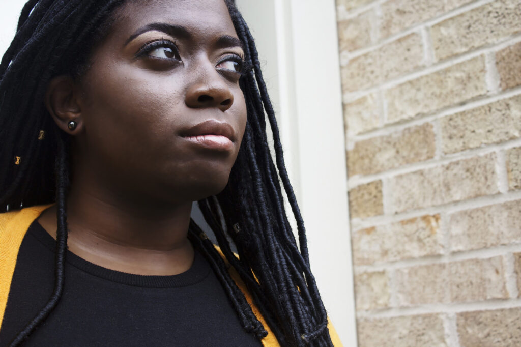 black-woman-looking-in-distance-createherstock