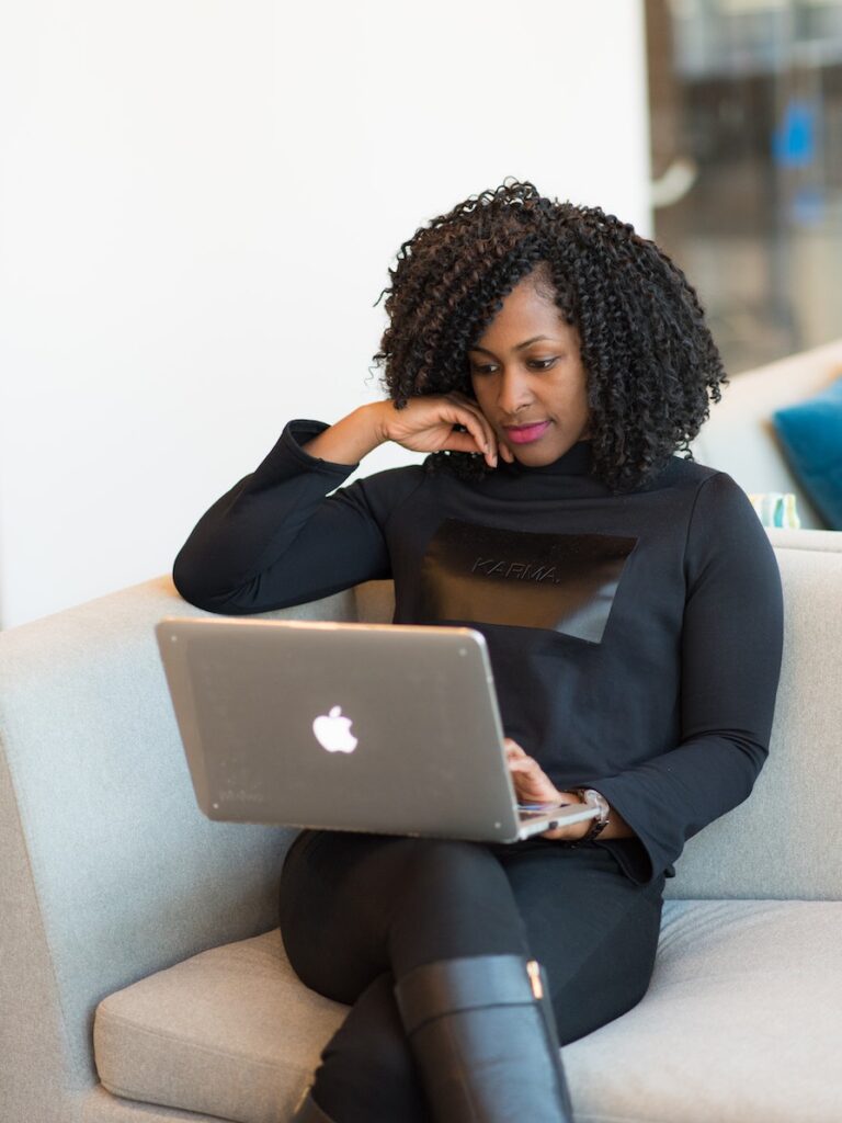 Image of an African-American woman sitting on her couch for an online therapy session in Atlanta, GA. You can connect with an online therapist in Georgia just as effectively as meeting with a counselor in person.