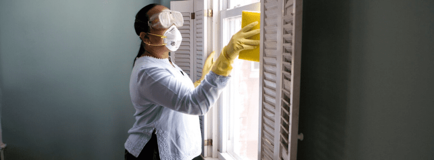 Black woman cleaning, reflecting the challenges of people-pleasing and the pressure to meet others' expectations