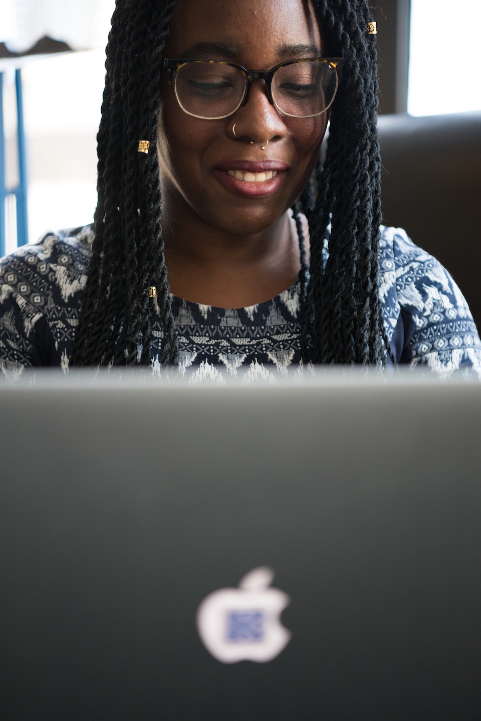 Image of a woman using an apple computer for her online therapy. Representing that with online counseling in Georgia you can speak with an Atlanta therapist from anywhere in the state.