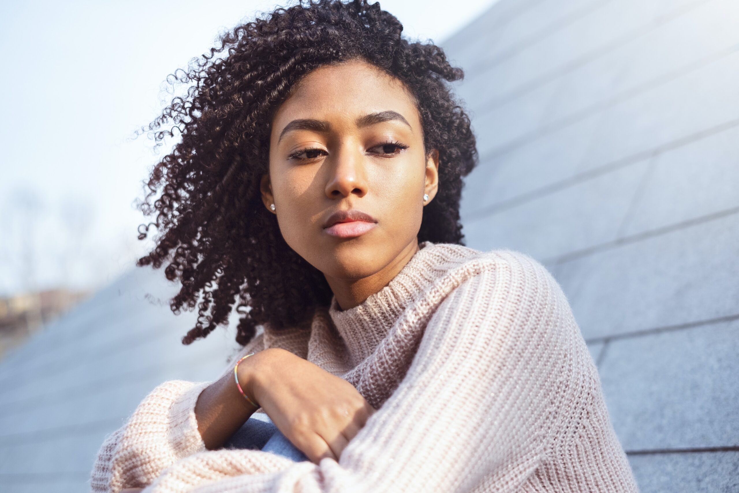Image of an African American woman looking off to the side. Representing the pain that grief and loss counseling can help with. During grief counseling in Atlanta, GA a grief counselor will help you make sense of life after loss.