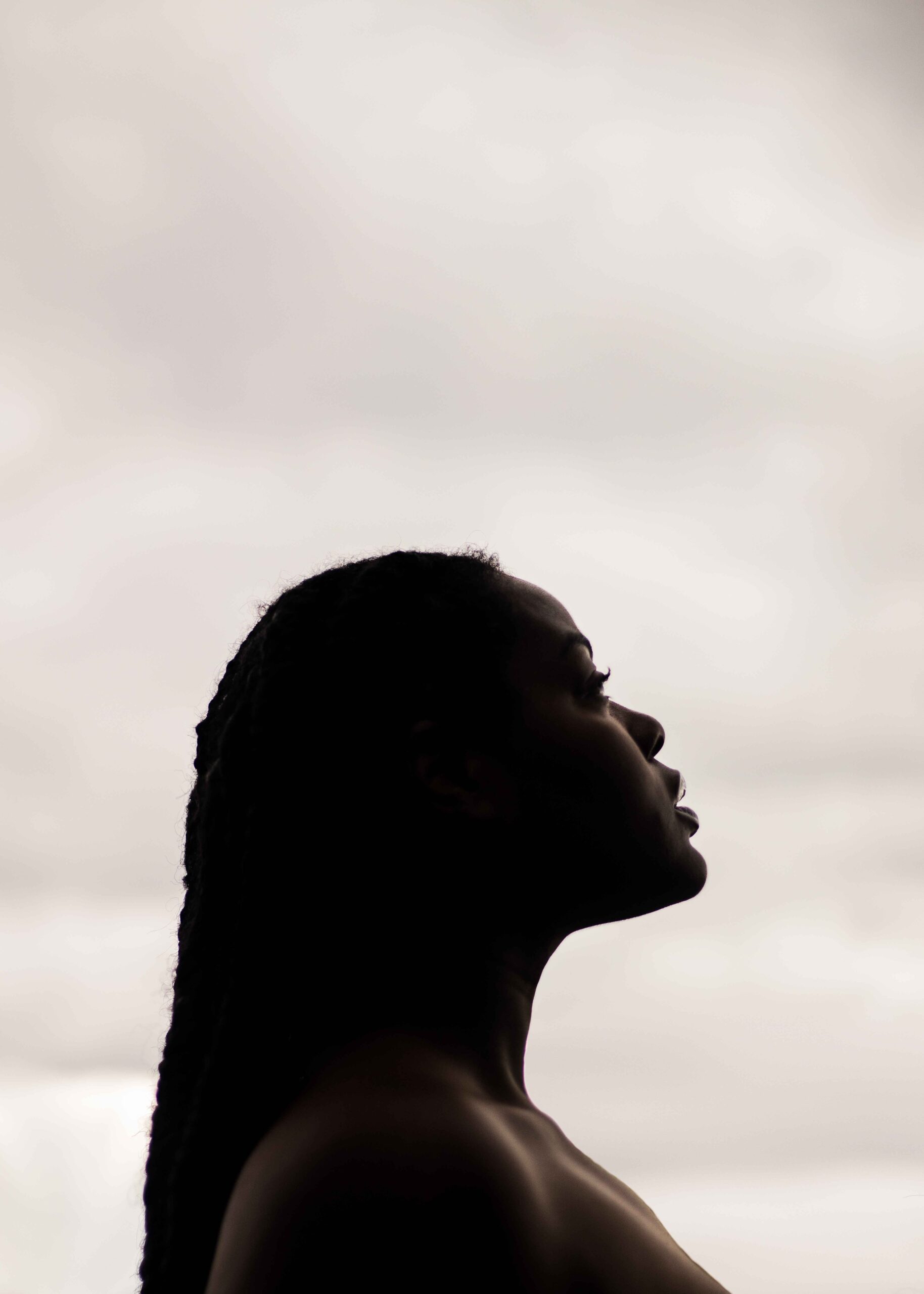 Image of a Black woman looking skyward. Representing the acceptance of loss of control that ACT for anxiety can give. An ACT therapist can help establish your values in ACT therapy in Atlanta, Georgia.