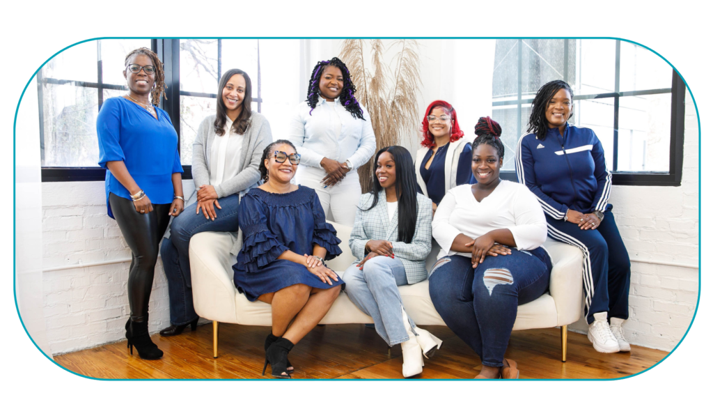 8 Black Therapists wearing blue and white posing for photo in natural light. Representing Simplicity Psychotherapy group practice for Black men and women