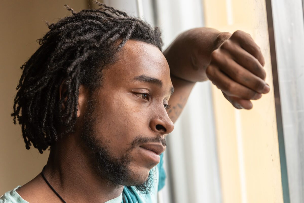 Image of an African America man that looks like he is suffering from depression symptoms. If you feel like this depression counseling can help. A therapist can help with managing depression in Atlanta, GA.