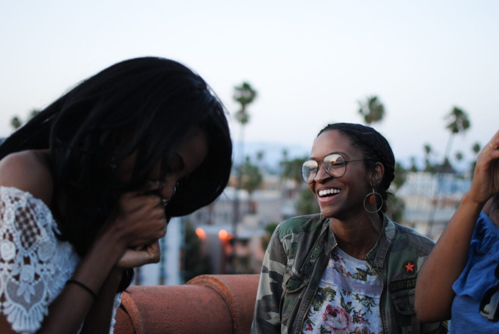 Women laughing and sharing in a group therapy session focused on emotional healing.