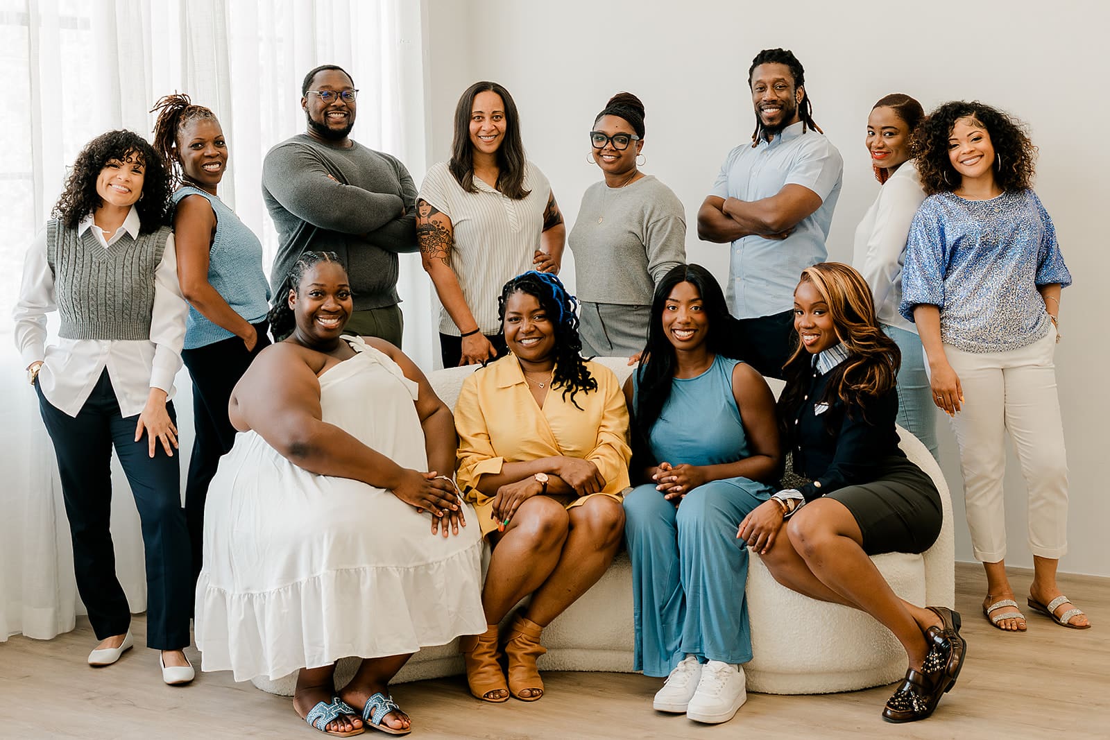 Eight Black Therapists wearing blue and white posing for photo in natural light. Representing Simplicity Psychotherapy group practice for Black men and women