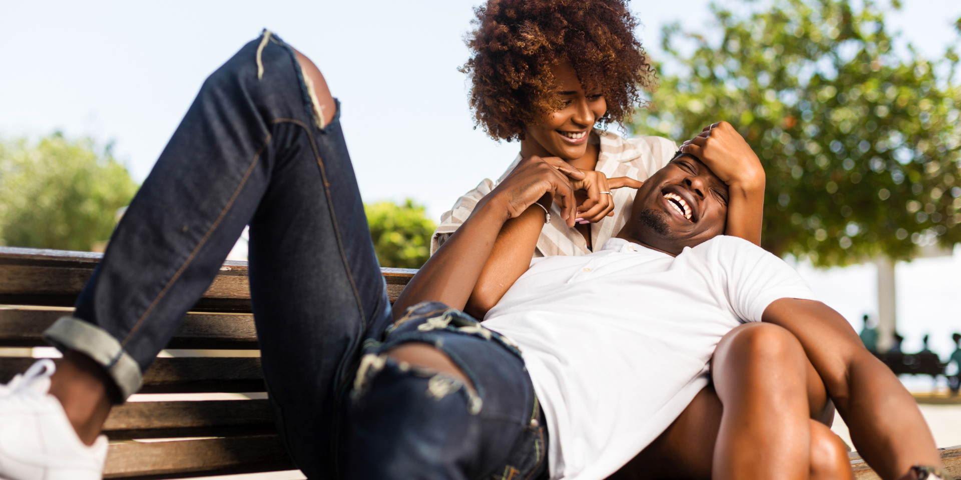 Image of a couple playfully cuddling on a bench. Representing the relationship that a black couples therapist can help you achieve. Black marriage counseling and black couples therapy in Atlanta is designed to help you enjoy time with your partner again.