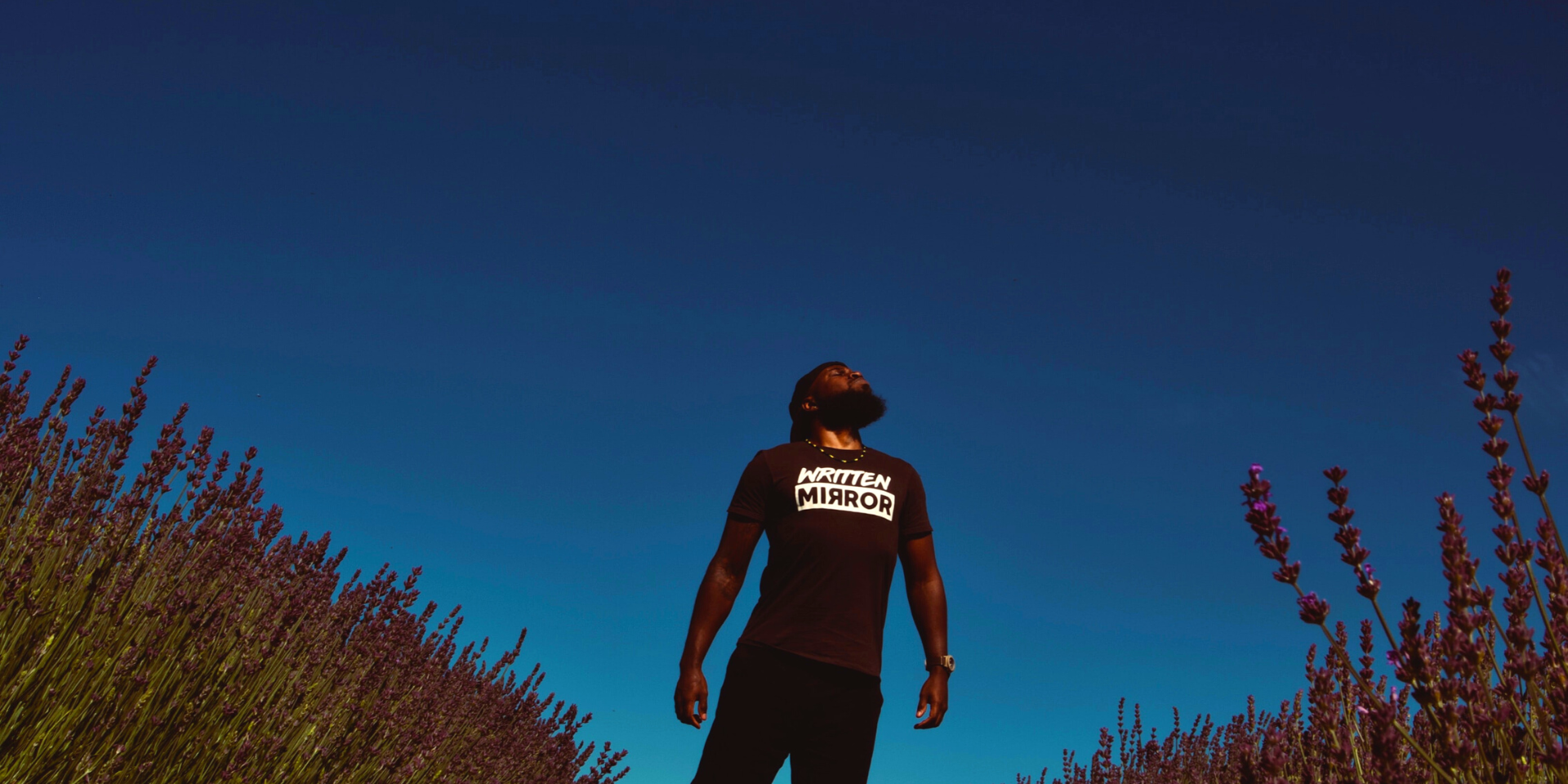 Image of a Black man standing proudly in front of a blue sky. Representing the freedom you can get with ACT therapy for anxiety or depression. Get support from an ACT therapist in Atlanta, Georgia.