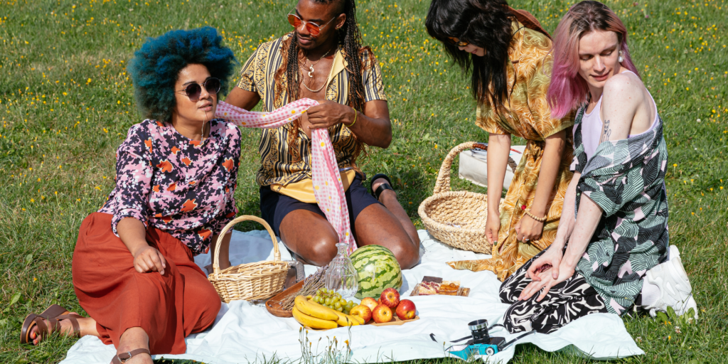 Image of a group of 4 people having a picnic in the park. Representing that anyone is welcome at LGBTQIA therapy in Atlanta, GA. With the right LGBTQ therapist near you in Atlanta, GA you can start getting LGBTQ counseling tailored your needs.