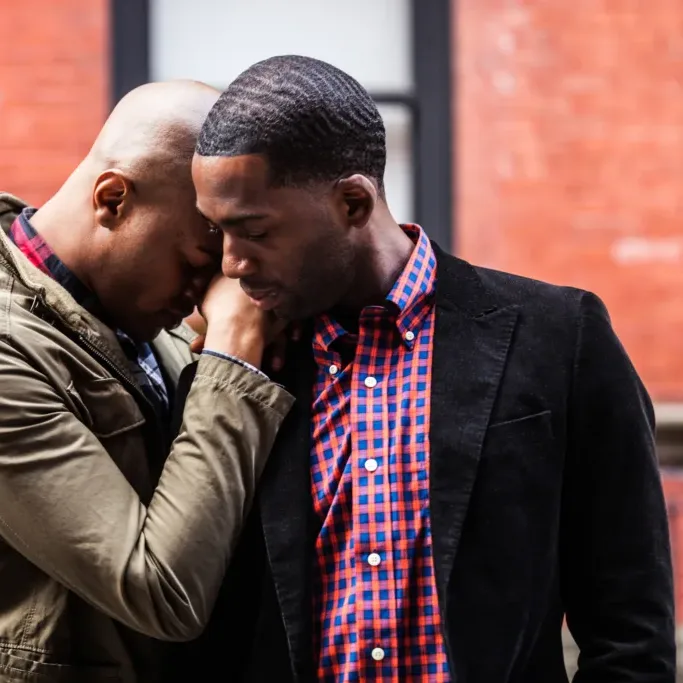 Image of a young African American male Homosexual couple embracing after meeting with an Atlanta relationship counselor. Address communication and relationship problems during relationship counseling in Atlanta, GA.